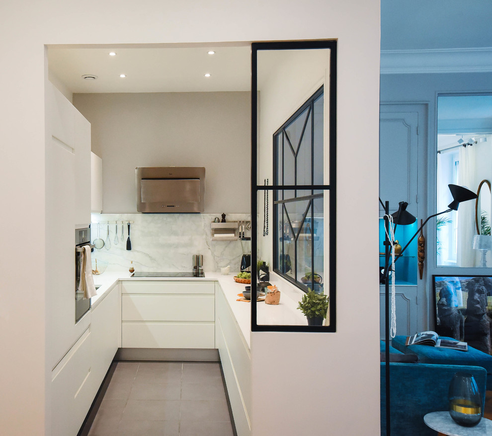 Modern inredning av ett kök, med luckor med profilerade fronter, vita skåp, vitt stänkskydd, rostfria vitvaror, mellanmörkt trägolv, en köksö och beiget golv