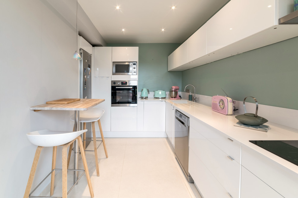This is an example of a medium sized scandinavian l-shaped enclosed kitchen in Paris with an integrated sink, white cabinets, quartz worktops, white splashback, glass sheet splashback, stainless steel appliances, ceramic flooring, no island, beige floors and white worktops.