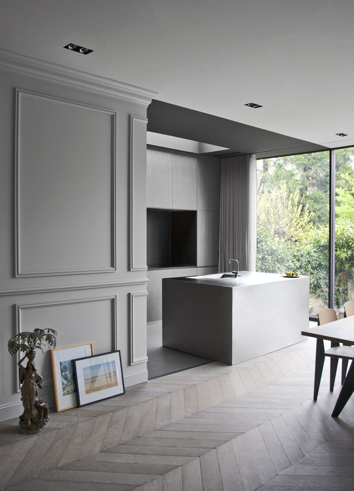 Contemporary galley kitchen/diner in Toulouse with flat-panel cabinets, grey cabinets and an island.