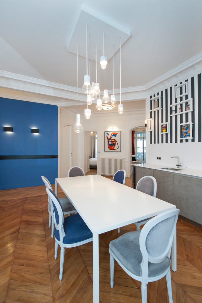 Medium sized contemporary open plan dining room in Paris with medium hardwood flooring and beige floors.