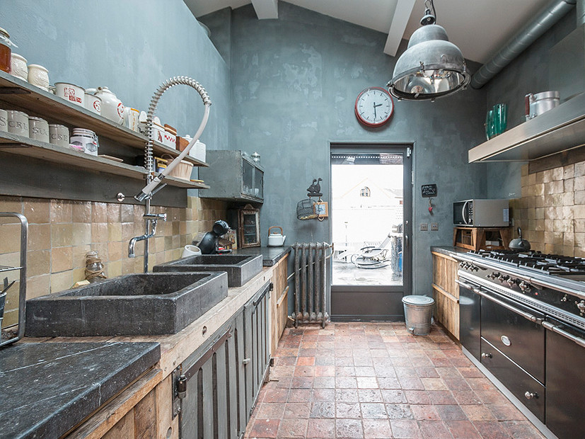 Medium sized industrial galley kitchen in Paris.