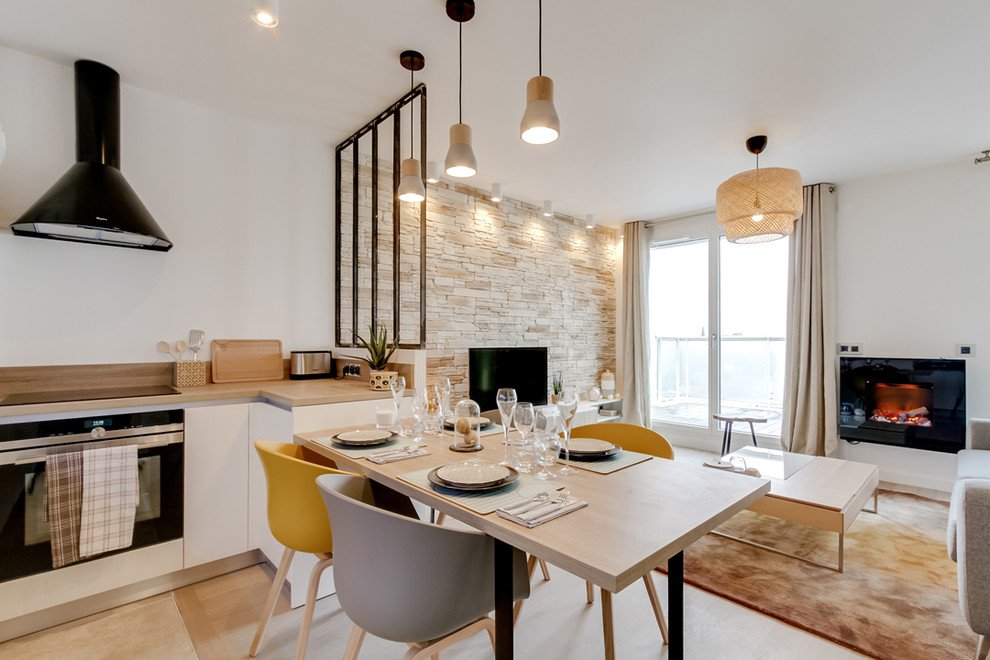 Photo of a medium sized scandinavian u-shaped kitchen/diner in Paris with an integrated sink, flat-panel cabinets, light wood cabinets, wood worktops, white splashback, integrated appliances, travertine flooring, no island and beige floors.