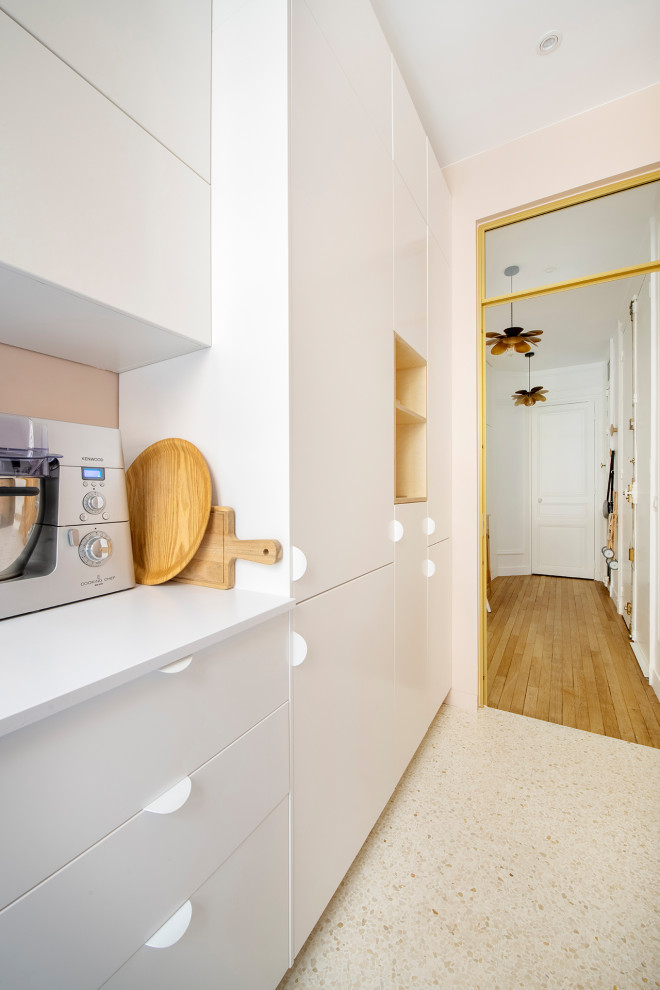 Design ideas for a small romantic galley enclosed kitchen in Paris with a submerged sink, beaded cabinets, pink cabinets, quartz worktops, white splashback, terracotta splashback, integrated appliances, terrazzo flooring, no island, white floors and pink worktops.