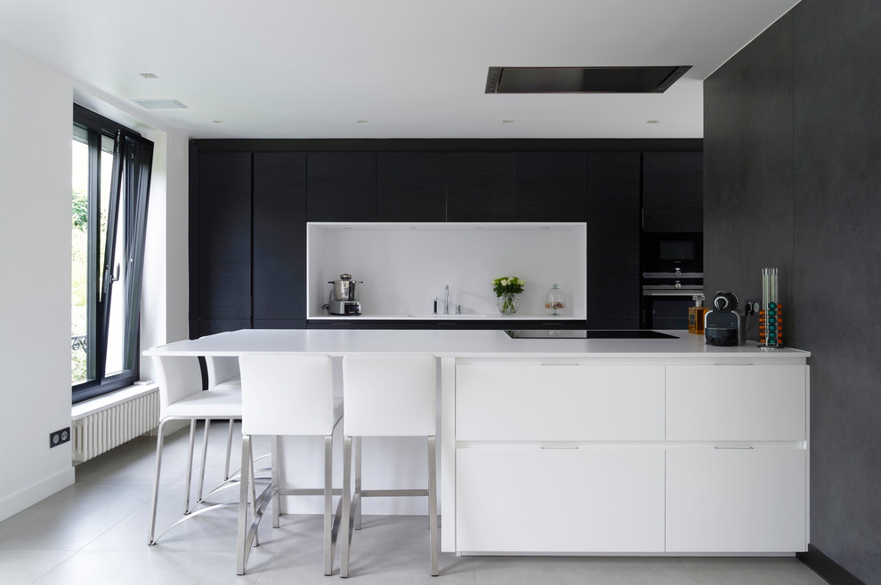 Moderne Küche mit Quarzwerkstein-Arbeitsplatte, Küchenrückwand in Weiß, Keramikboden, flächenbündigen Schrankfronten, weißen Schränken, Halbinsel und grauem Boden in Paris