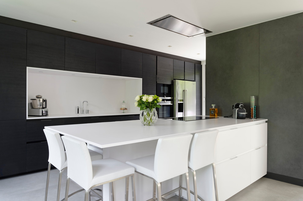 Design ideas for a modern kitchen/diner in Paris with a submerged sink, recessed-panel cabinets, dark wood cabinets, engineered stone countertops, white splashback, stainless steel appliances, ceramic flooring, an island and white floors.