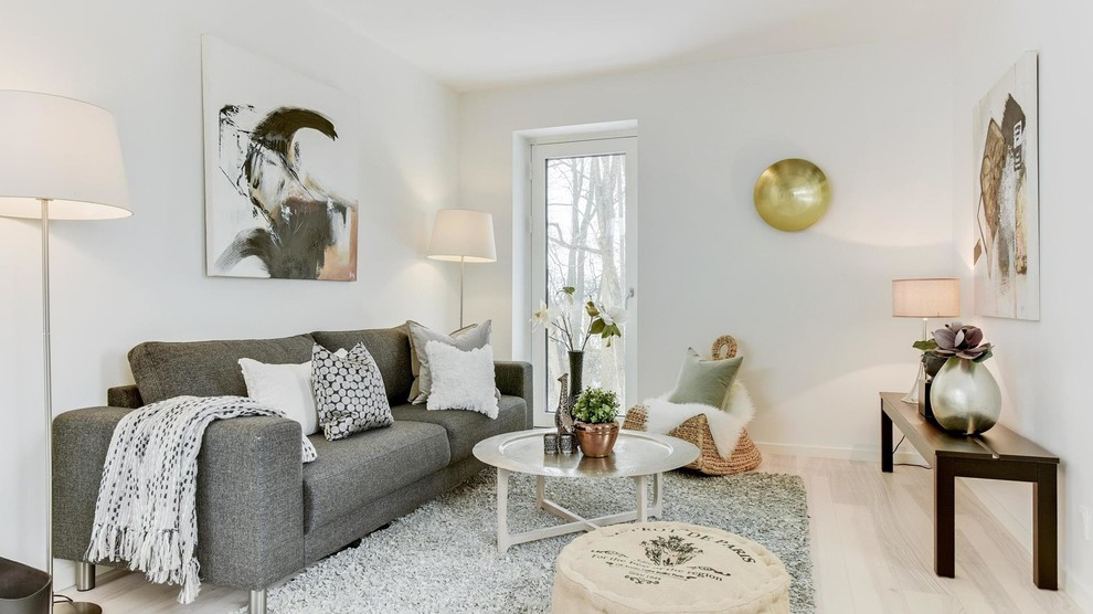 This is an example of a small contemporary formal enclosed living room in Copenhagen with white walls, light hardwood flooring and beige floors.