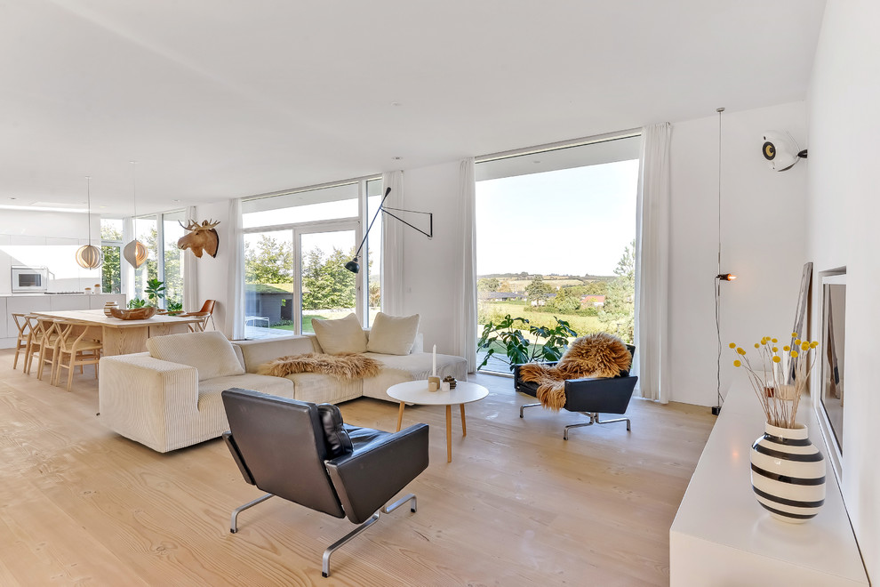 Mid-sized danish open concept living room photo in Aarhus with white walls