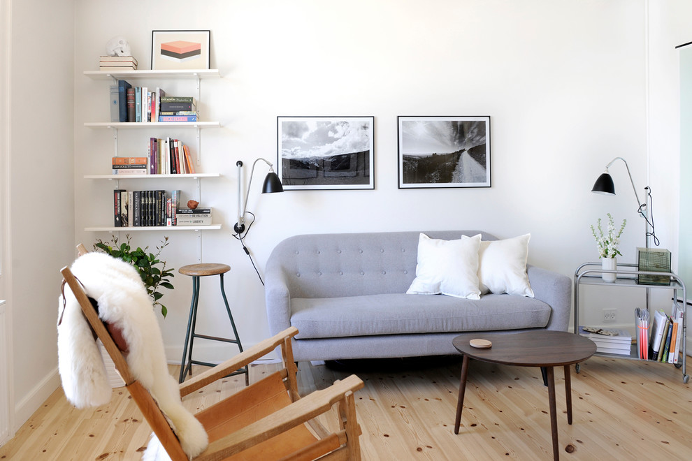 Living room - mid-sized scandinavian formal and enclosed light wood floor living room idea in Other with white walls, no fireplace and no tv