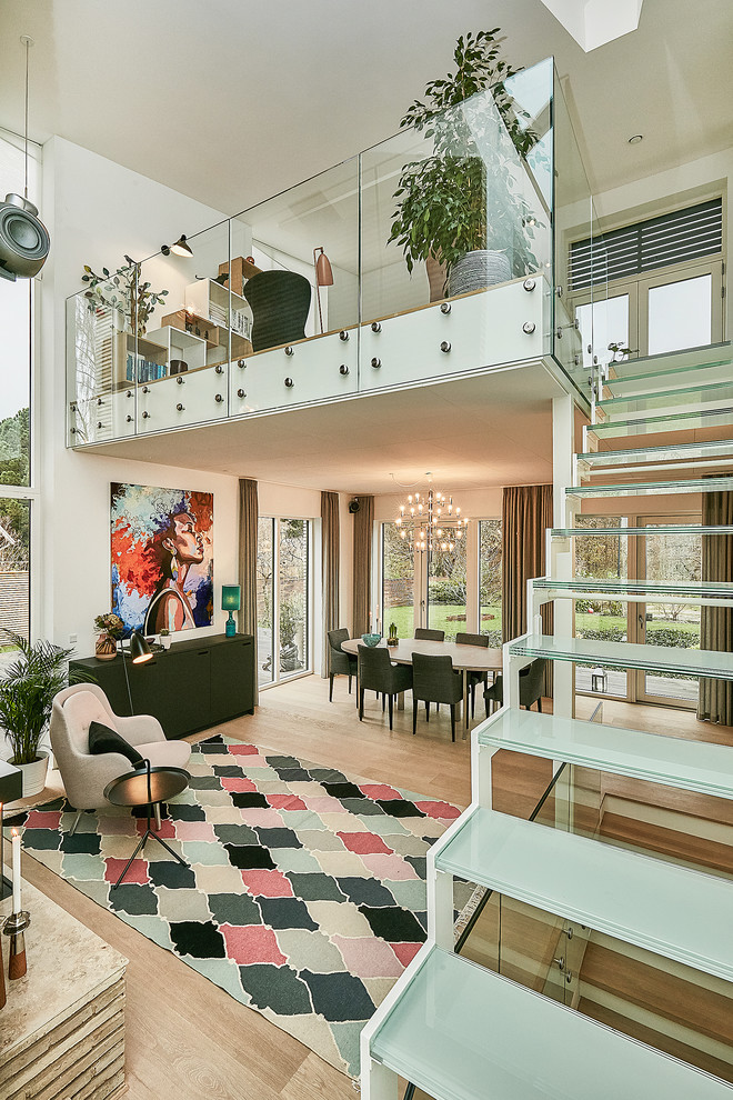 Design ideas for a medium sized contemporary mezzanine living room in Copenhagen with light hardwood flooring.