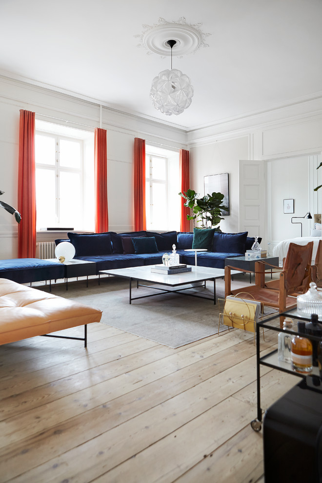 Example of a large transitional enclosed light wood floor and beige floor living room design in Aarhus with white walls