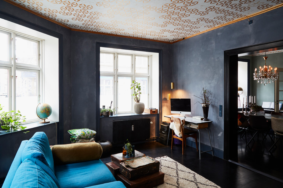 Imagen de salón cerrado bohemio sin chimenea con paredes negras, suelo de madera pintada y suelo negro