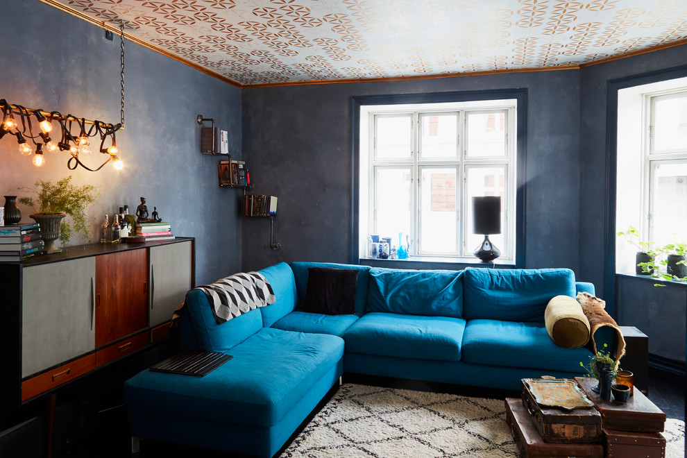Inspiration for an industrial enclosed living room remodel in Copenhagen with black walls