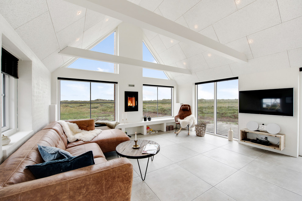 Источник вдохновения для домашнего уюта: открытая гостиная комната в скандинавском стиле с белыми стенами и телевизором на стене