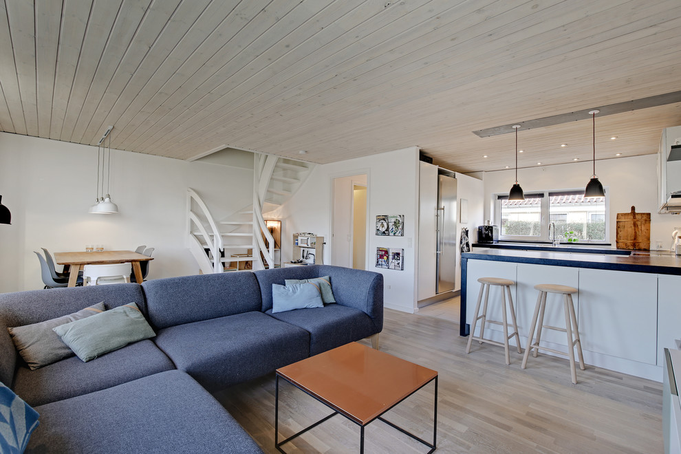 Immagine di un soggiorno scandinavo aperto con pareti bianche, parquet chiaro e nessun camino