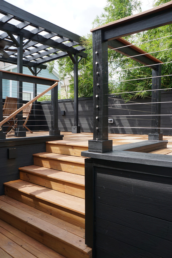 This is an example of a medium sized modern back terrace in Houston with a roof extension.