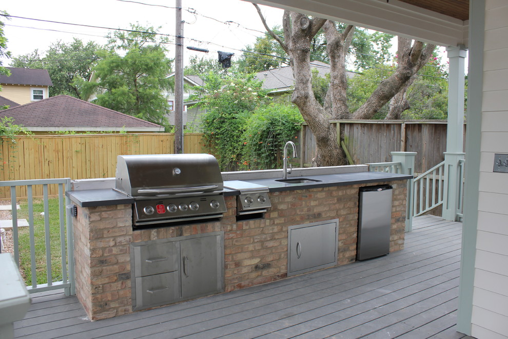 Design ideas for a medium sized traditional back terrace in Houston with an outdoor kitchen and a roof extension.