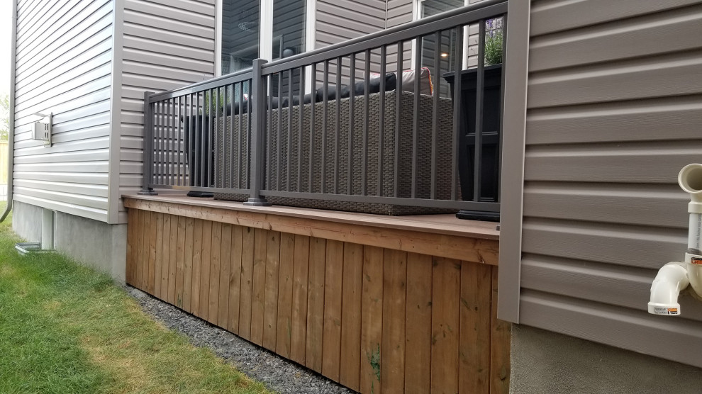 This is an example of a medium sized modern side terrace in Ottawa with skirting.