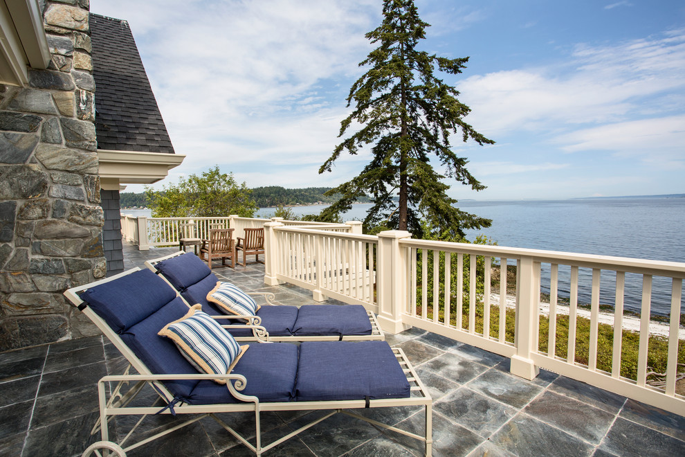 This is an example of a large coastal roof terrace in Seattle with no cover.