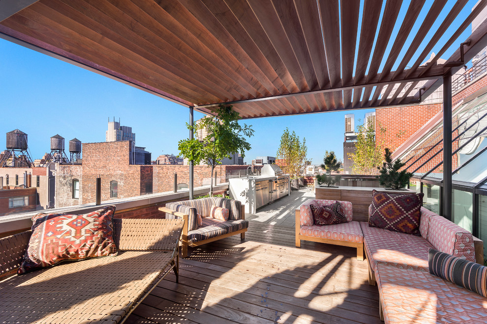 Outdoor kitchen deck - huge contemporary rooftop outdoor kitchen deck idea in New York with a pergola
