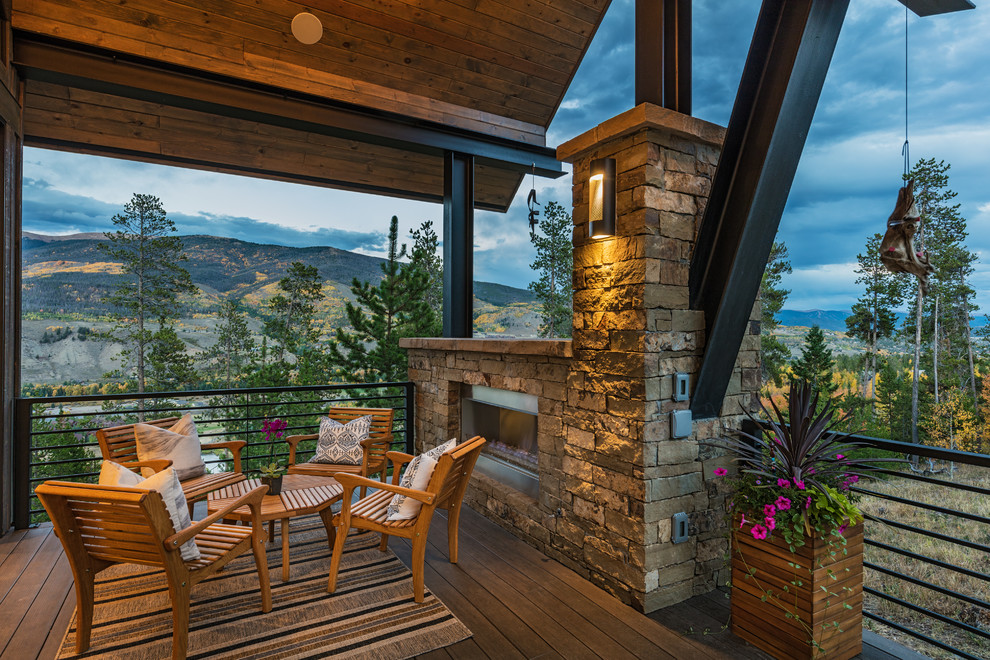 Design ideas for a rustic terrace in Denver with a fireplace and a roof extension.