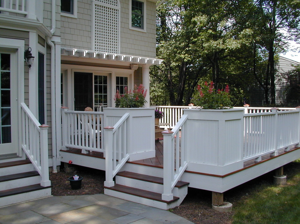 Deck - mid-sized traditional backyard deck idea in New York with a pergola