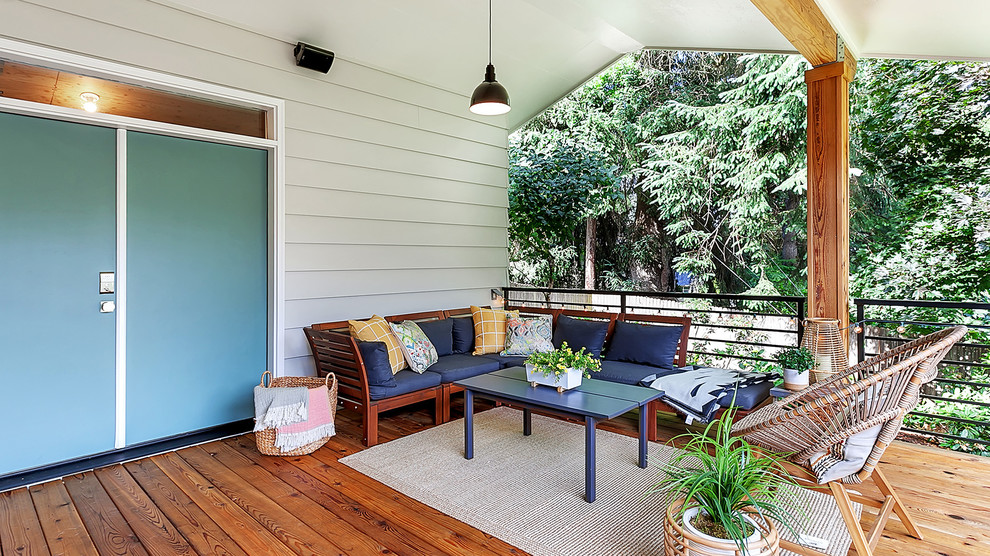 Photo of a large retro back terrace in Portland with a roof extension.
