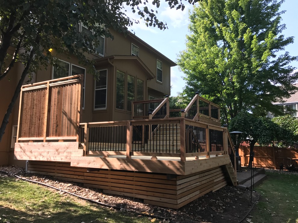 Example of an arts and crafts backyard deck design in Kansas City