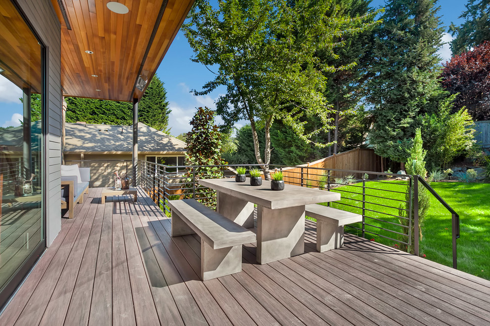 This is an example of a large contemporary back terrace in Seattle with a roof extension.