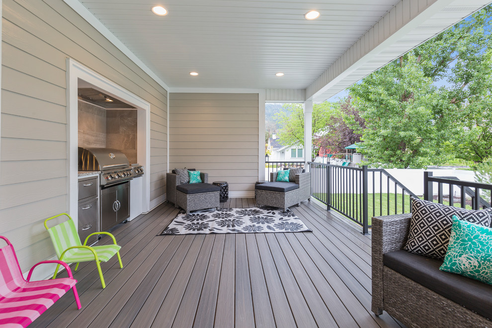 Inspiration for a transitional outdoor kitchen deck remodel in Salt Lake City with a roof extension