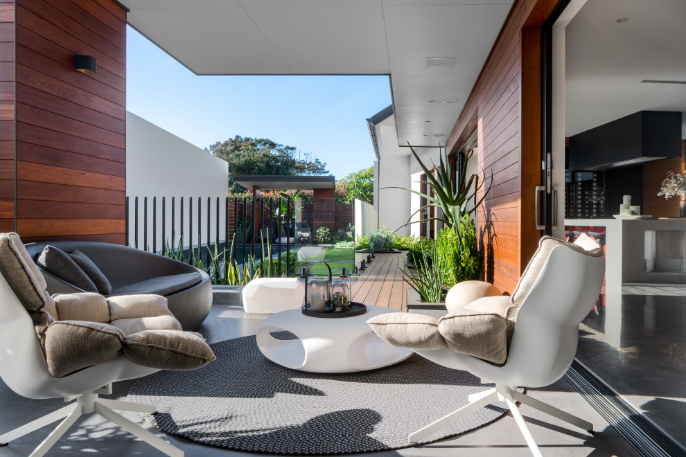 Large trendy backyard deck photo in Sydney with a roof extension