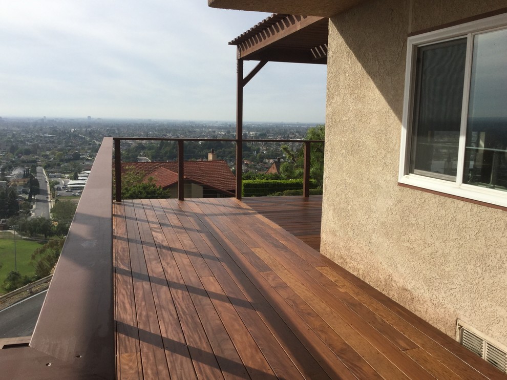 This is an example of a large modern back terrace in Orange County with no cover.