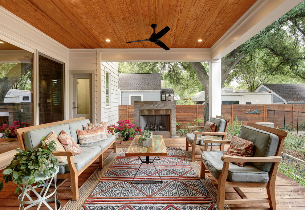 Cette image montre une terrasse craftsman avec un foyer extérieur et une extension de toiture.