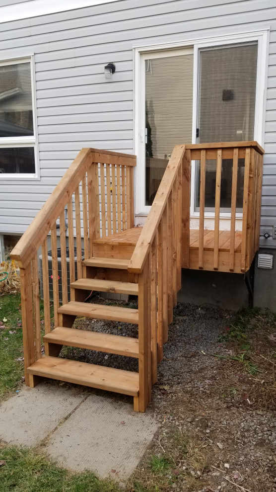 Photo of a small traditional back ground level wood railing terrace in Ottawa with no cover.