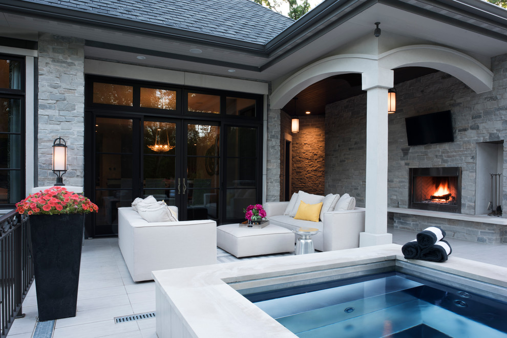 Inspiration for a large backyard deck remodel in Milwaukee with a fireplace and a roof extension
