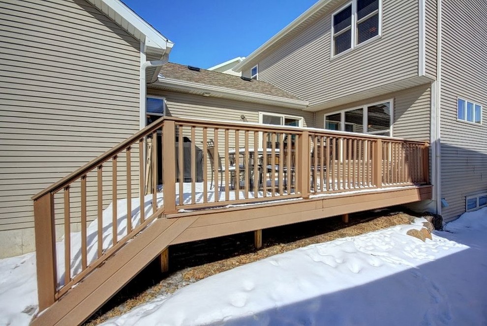 Example of a mid-sized classic backyard deck design in Other with no cover