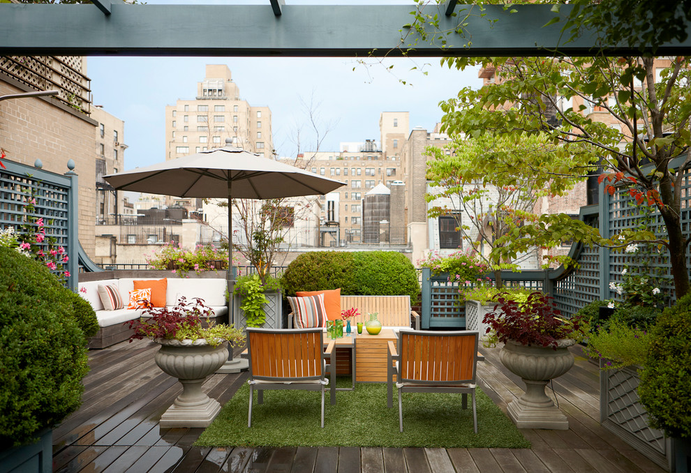 Classic roof rooftop terrace in New York with no cover and a potted garden.