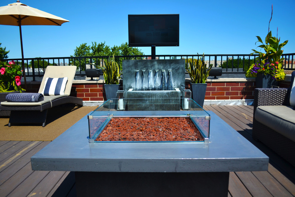 Large trendy rooftop deck photo in Chicago with a fire pit and no cover