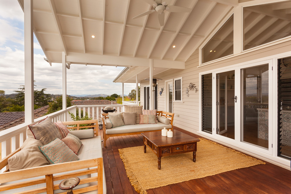 Inspiration for a mid-sized coastal rooftop second story deck remodel in Other with a roof extension