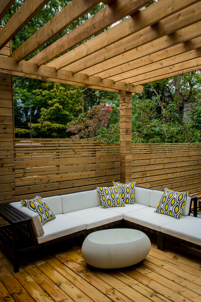 Large trendy rooftop deck photo in Toronto with a pergola