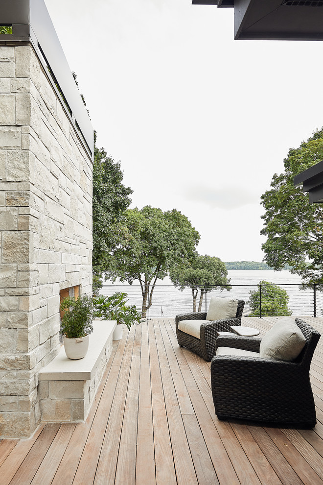 This is an example of a contemporary terrace in Minneapolis with a fireplace and no cover.