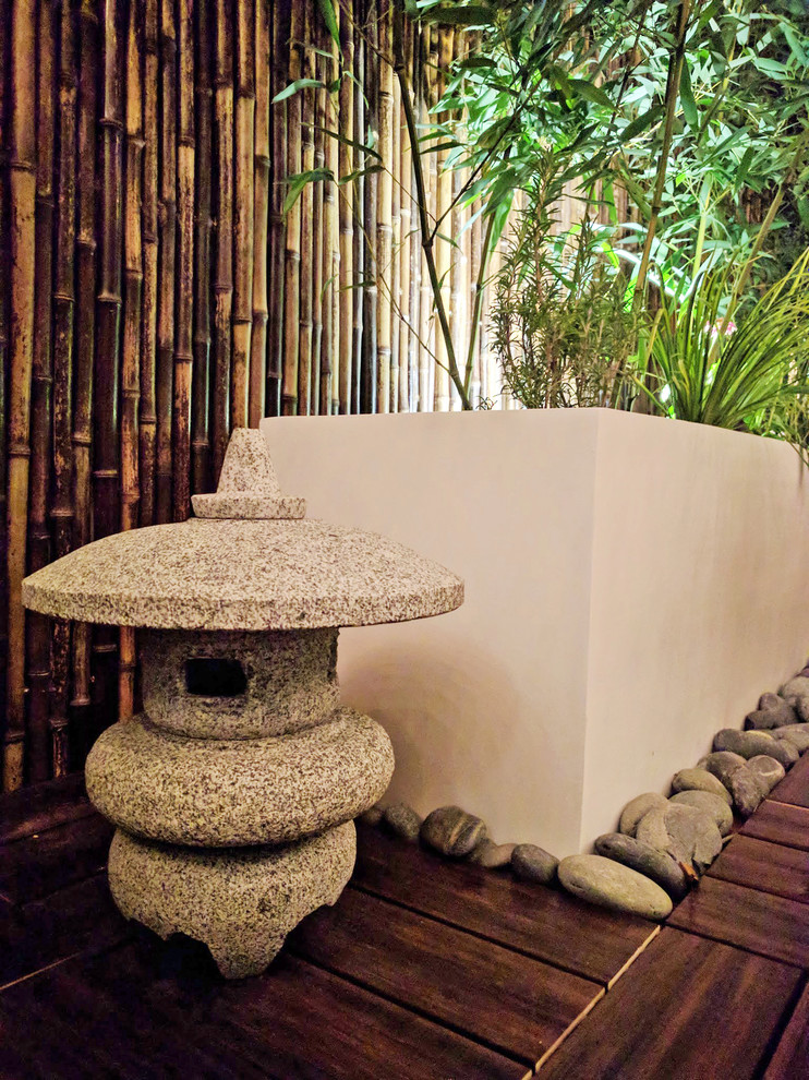 Imagen de terraza asiática de tamaño medio sin cubierta en patio trasero con jardín de macetas