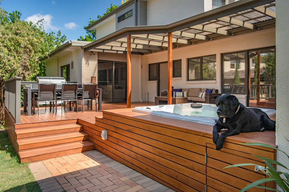 Inspiration for a large contemporary back terrace in Canberra - Queanbeyan with a pergola.
