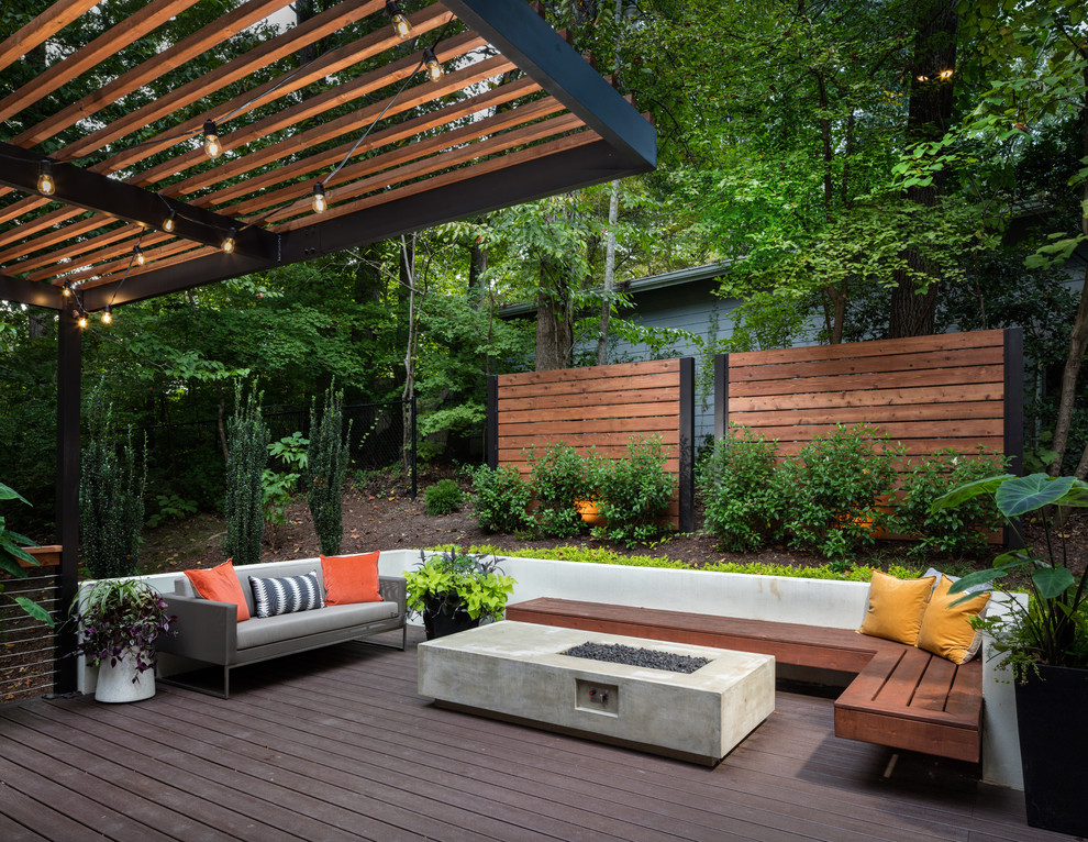 Large contemporary back terrace in Atlanta with a pergola and feature lighting.