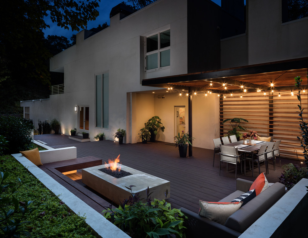 Photo of a large contemporary back ground level metal railing terrace in Atlanta with a pergola and feature lighting.
