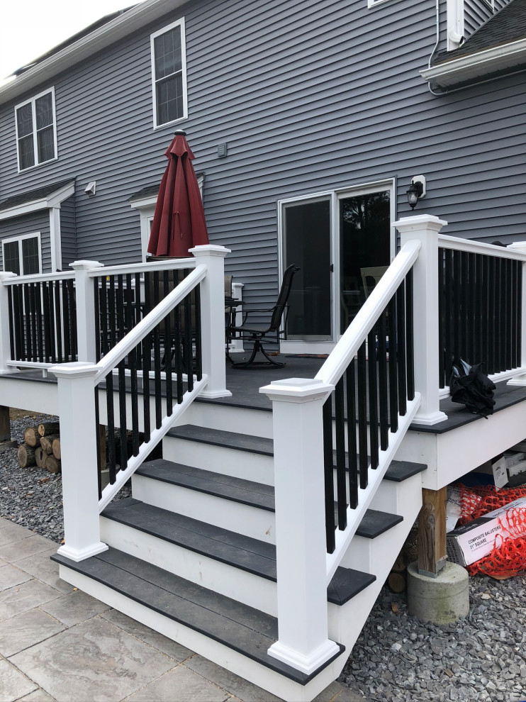 Deck - small modern backyard privacy deck idea in Boston with no cover