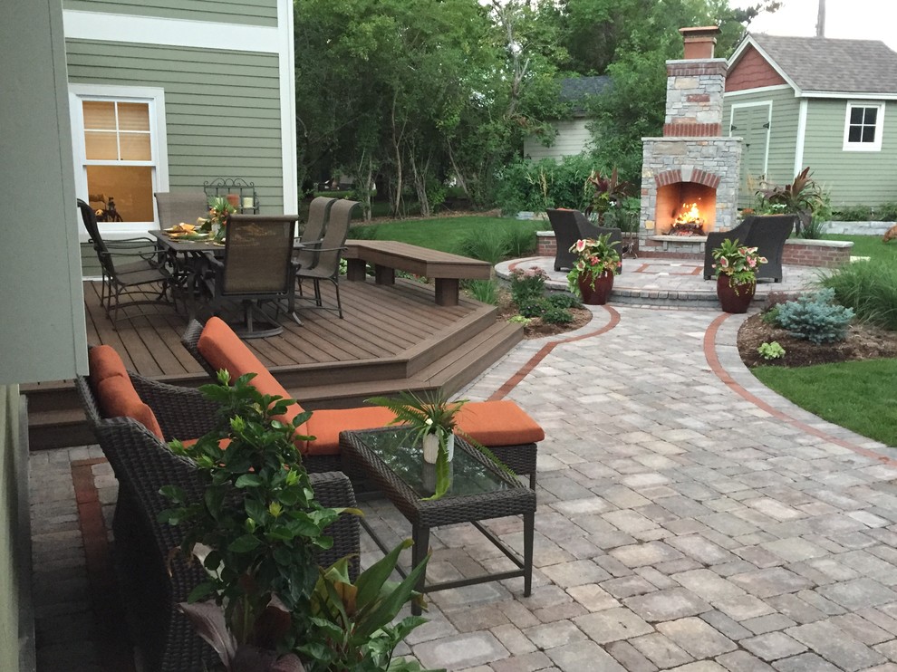 Medium sized rustic back terrace in Minneapolis with a fireplace.