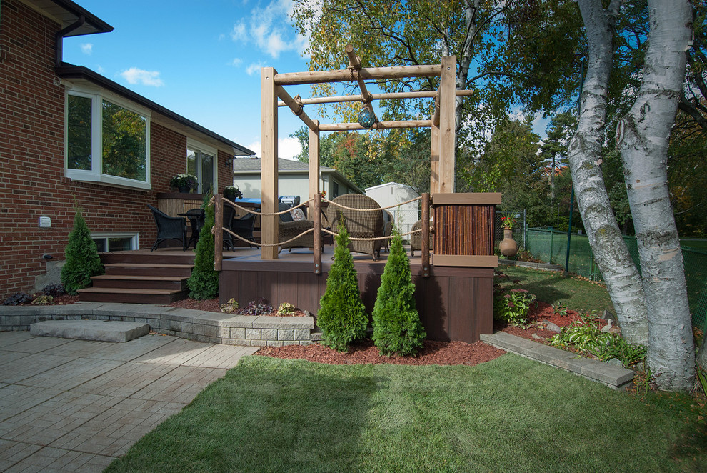 This is an example of a small nautical back terrace in Toronto with an outdoor kitchen and a pergola.