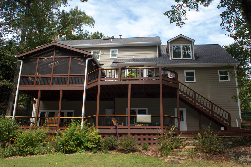 Huge transitional backyard deck photo in Atlanta with a roof extension