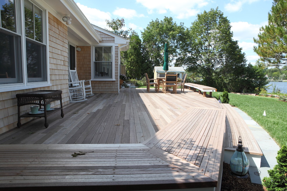 This is an example of a large beach style back terrace in Providence.