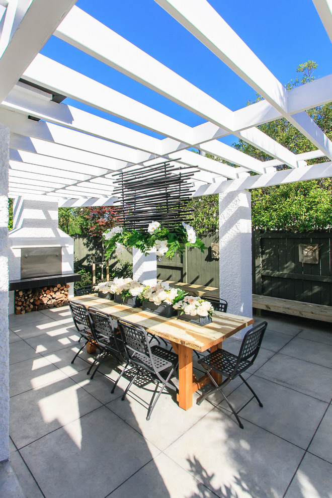 Contemporary patio in Other with a pergola.